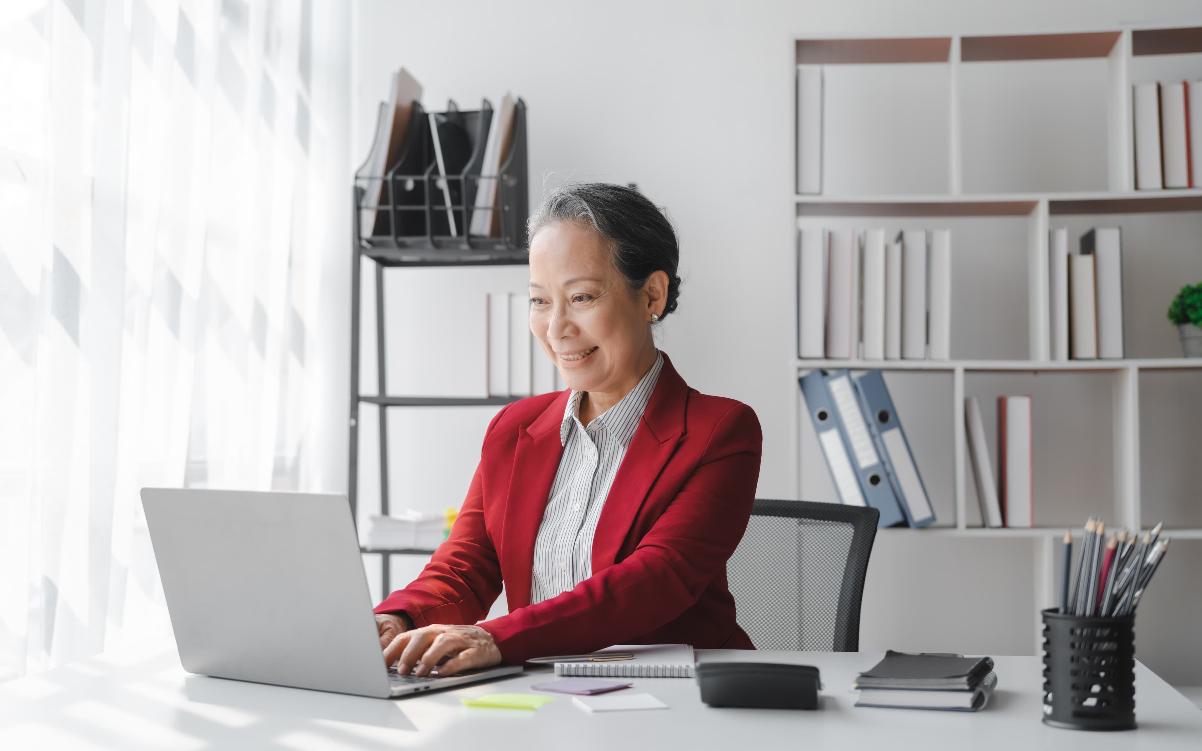 Professional woman working on laptop in modern office